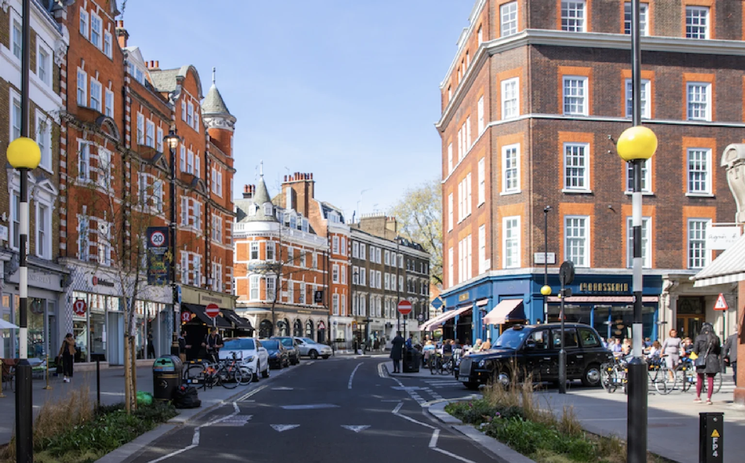 A Marylebone street of red-brick mansion blocks and pavement cafés